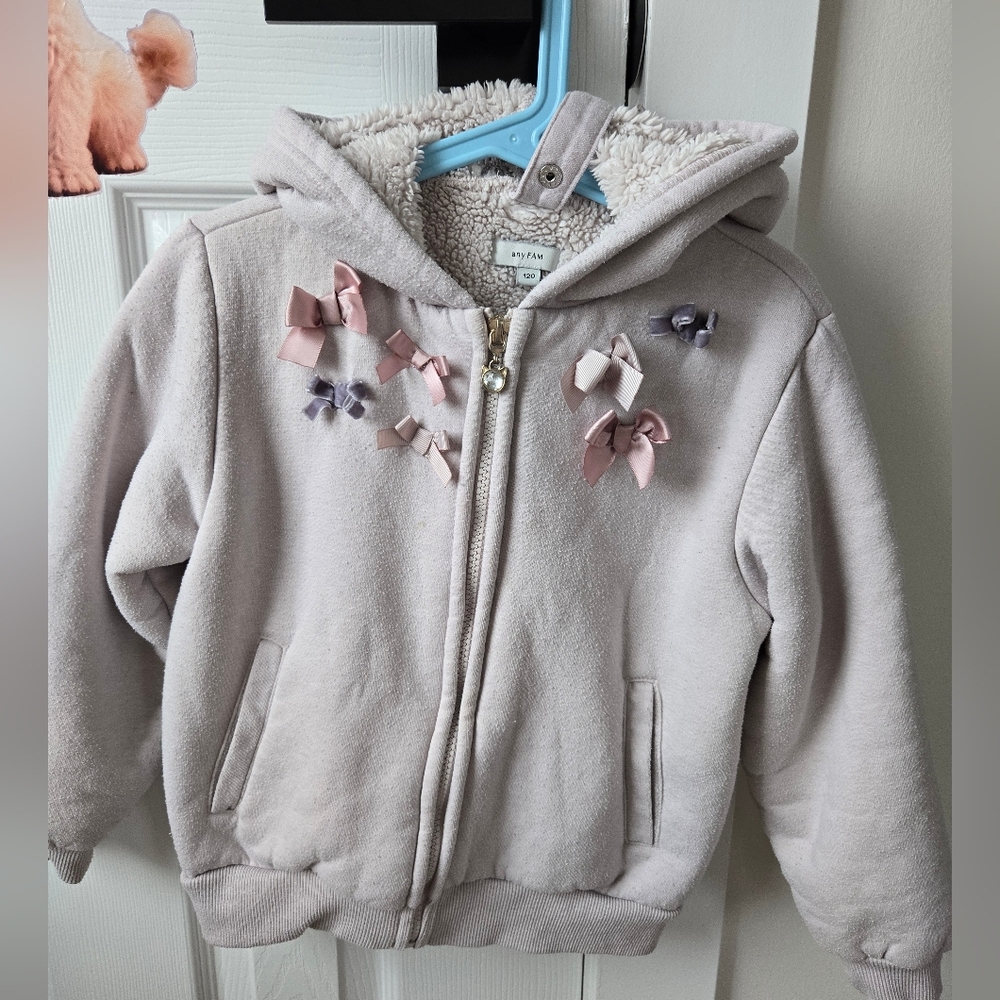 Charming Kids' Cream Hoodie with Bow Accents